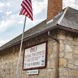 Pony Express sign on stone building